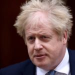 FILE PHOTO: British PM Johnson walks outside Downing Street in London